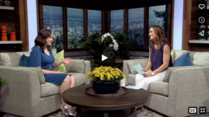 Photo is a screenshot from Maegan's interview on Afternoon Live and features Maegan sitting on a couch across from the host, who is also sitting on a couch.