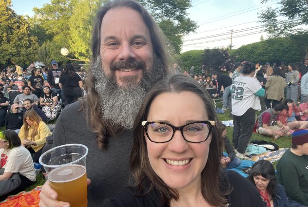 Photo of Maegan, white woman with galsses and brown hair, and her husband Jonathan, white man with long brown hair and a long beard.